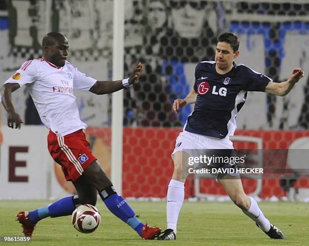 Hamburg's French midfielder Guy Demel and Fulham's Hungarian midfielder Zoltan Gera vie for the ball during the first leg UEFA Europa League...