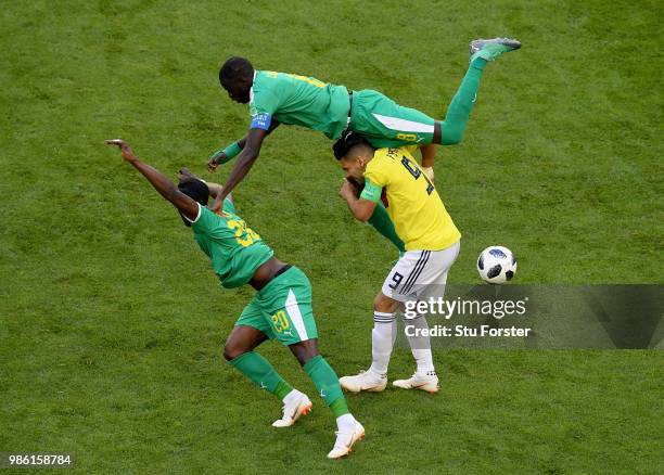 Radamel Falcao of Colombia is tackled by Cheikhou Kouyate and Keita Balde of Senegal during the 2018 FIFA World Cup Russia group H match between...