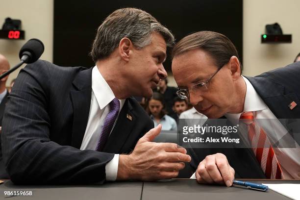 Deputy Attorney General Rod Rosenstein and FBI Director Christopher Wray talk prior to a hearing before the House Judiciary Committee June 28, 2018...