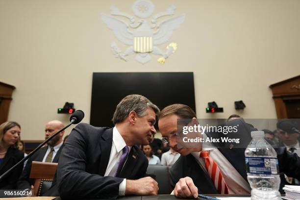 Deputy Attorney General Rod Rosenstein and FBI Director Christopher Wray talk prior to a hearing before the House Judiciary Committee June 28, 2018...