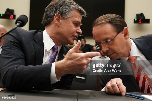 Deputy Attorney General Rod Rosenstein and FBI Director Christopher Wray talk prior to a hearing before the House Judiciary Committee June 28, 2018...