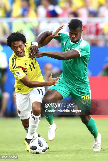 Juan Cuadrado of Colombia battles for possession with Keita Balde of Senegal during the 2018 FIFA World Cup Russia group H match between Senegal and...