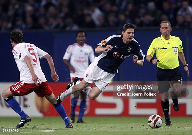 Joris Mathijsen of Hamburg and Zoltan Gera of Fulham compete for the ball during the UEFA Europa League semi final first leg match between Hamburger...