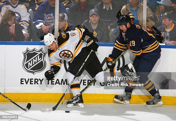 Dennis Wideman of the Boston Bruins skates against Tim Connolly of the Buffalo Sabres in Game Two of the Eastern Conference Quarterfinals during the...