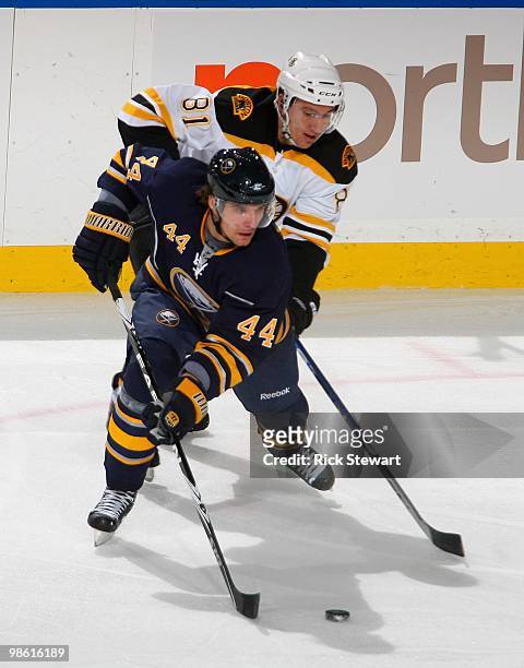 Andrej Sekera of the Buffalo Sabres skates ahead of Miroslav Satan of the Boston Bruins in Game Two of the Eastern Conference Quarterfinals during...