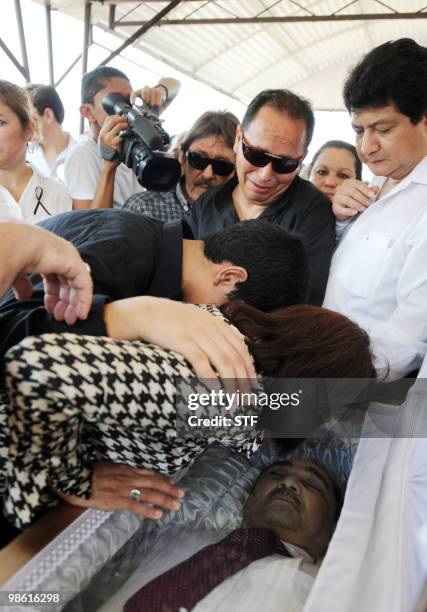 Silvia Munguia , widow of television journalist and university professor Jorge Alberto Orellana, gives him a last kiss on his forehead prior to his...