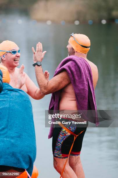 two male open water swimmers congratulating each other - gary bond stock pictures, royalty-free photos & images