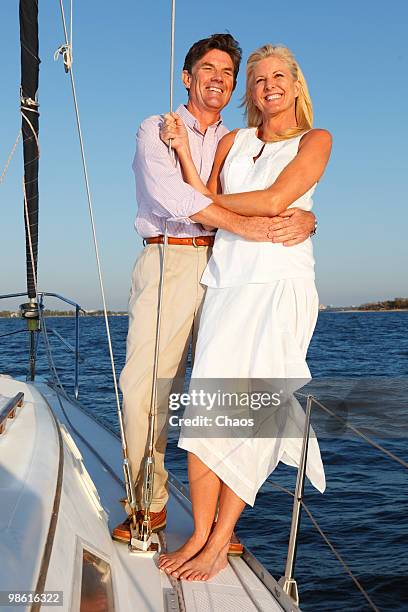 man and woman embracing at sunset on a sailboat - newoutdoors stock pictures, royalty-free photos & images