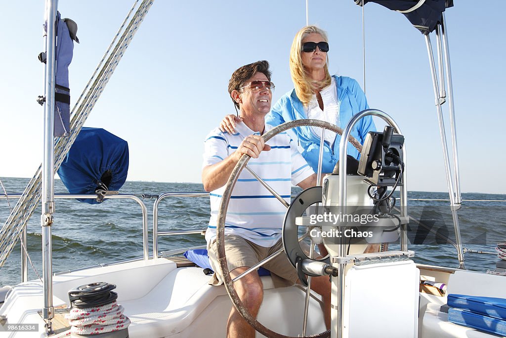 Active couple sailing at sea.
