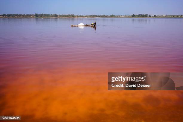 Plumes of orange and red on Lac Rose on the edge of Dakar, Senegal. Lac Rose is a saline lake that gets its color from a special type of algae and...