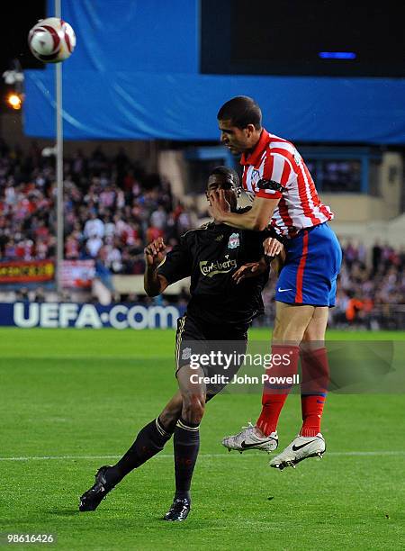 David N'Gog of Liverpool goes up with Alvaro Dominguez of Athletico Madrid during the UEFA Europa League Semi-Finals First Leg match between Atletico...