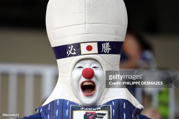 Disguised Japan's fan reacts before the Russia 2018 World Cup Group H football match between Japan and Poland at the Volgograd Arena in Volgograd on...