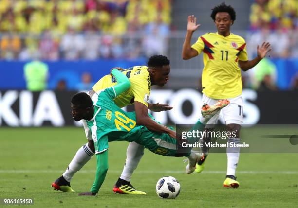 Mbaye Niang of Senegal is challenged by Yerry Mina of Colombia during the 2018 FIFA World Cup Russia group H match between Senegal and Colombia at...