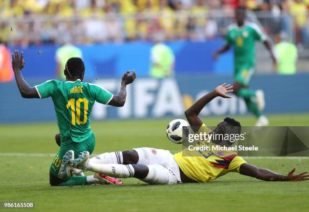 Davinson Sanchez of Colombia slides in to tackle Sadio Mane of Senegal for incident that was reviewed to VAR with no penalty awarded during the 2018...