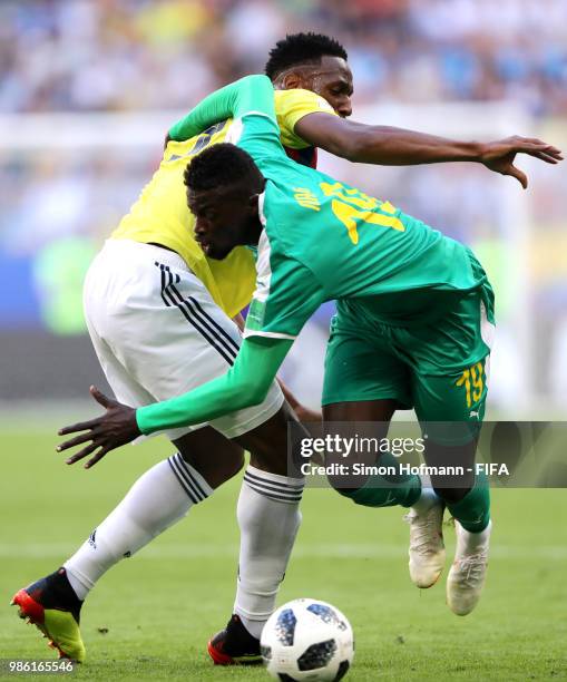 Mbaye Niang of Senegal is challenged by Yerry Mina of Colombia during the 2018 FIFA World Cup Russia group H match between Senegal and Colombia at...