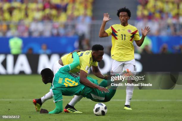 Mbaye Niang of Senegal is challenged by Yerry Mina of Colombia during the 2018 FIFA World Cup Russia group H match between Senegal and Colombia at...