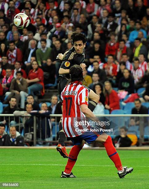 Yossi Benayoun of Liverpool headers the ball past Tomas Ujfalusi of Athletico Madrid during the UEFA Europa League Semi-Finals First Leg match...