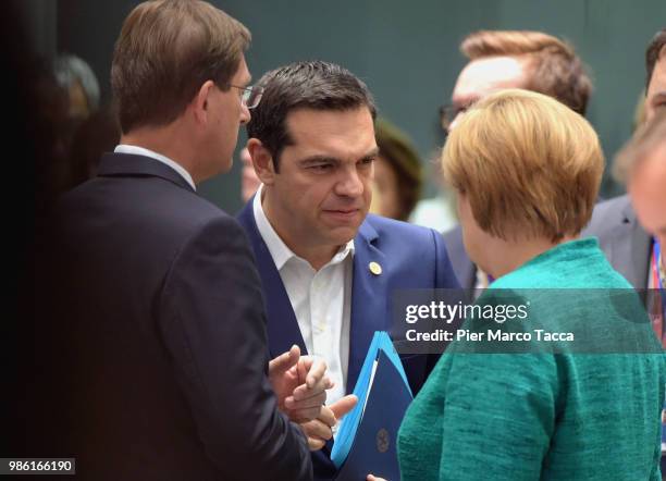 Alexis Tsipras, Prime Minister of Greece speaks with Angela Merkel, Federal Chancellor during the EU Council Meeting at European Parliament on June...