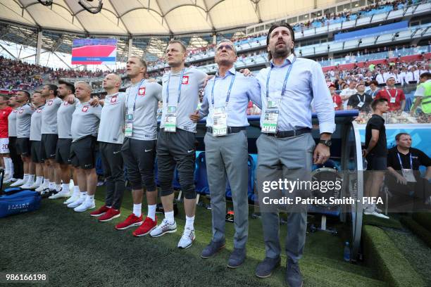 The Poland bench looks on during the national anthem prior to the 2018 FIFA World Cup Russia group H match between Japan and Poland at Volgograd...