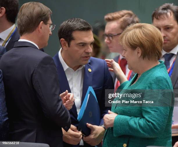 Alexis Tsipras, Prime Minister of Greece speaks with Angela Merkel, Federal Chancellor during the EU Council Meeting at European Parliament on June...