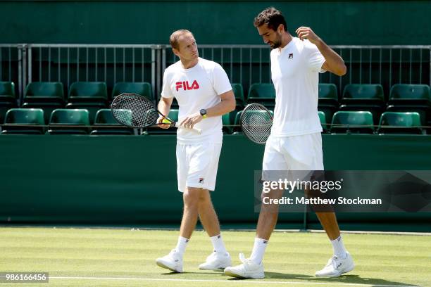 Coach Ivan Cinkus and Marin Cilic of Craotia confer on court during training for the Wimbledon Lawn Tennis Championships at the All England Lawn...