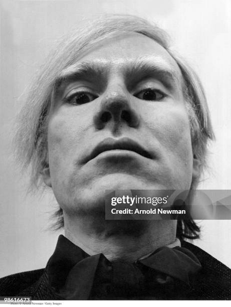 Low-angle, close-up portrait of American Pop artist Andy Warhol as he poses in his studio, the Factory, New York, New York, February 2, 1973.