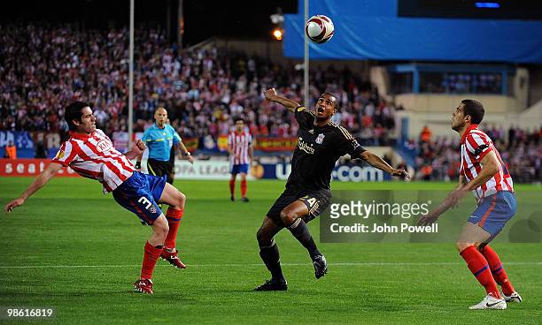 David N'Gog of Liverpool competes with Alvaro Dominguez and Antonio Loez both of Athletico Madrid during the UEFA Europa League Semi-Finals First Leg...