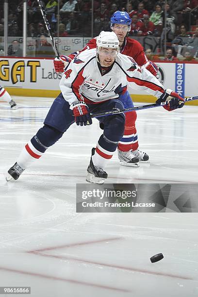 Tomas Fleischmann of the Washington Capitals skates for the puck inf ront of Marc-Andre Bergeron of Montreal Canadiens in the Game Three of the...