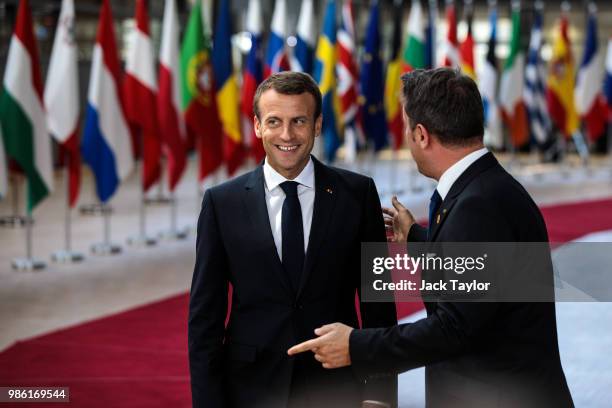 French President Emmanuel Macron greets Luxembourg's Prime Minister Xavier Bettel as they arrive at the Council of the European Union on the first...