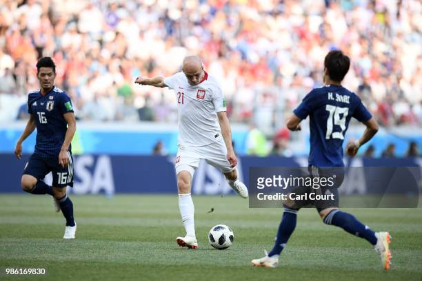 Rafal Kurzawa of Poland takes a shot past Hiroki Sakai of Japan during the 2018 FIFA World Cup Russia group H match between Japan and Poland at...