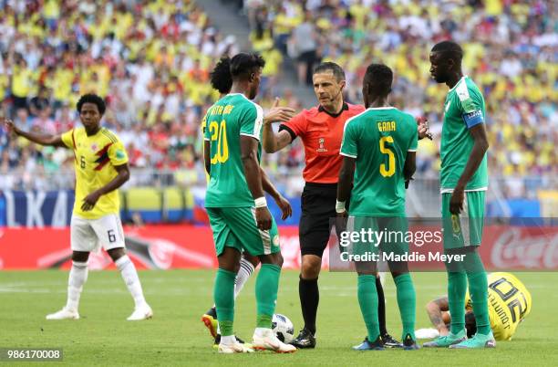 Referee Milorad Mazic speaks with Senegal players after a foul on Juan Quintero of Colombia during the 2018 FIFA World Cup Russia group H match...