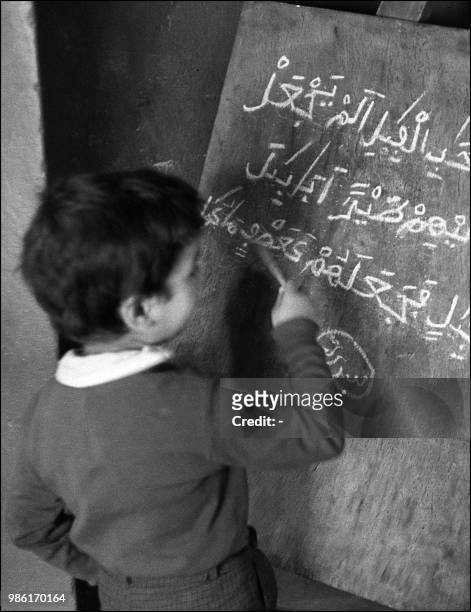 Un petit écolier travaille au tableau noir dans une école de la Casbah à Alger au mois de novembre 1968.