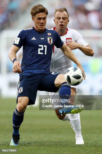 Gotoku Sakai of Japan is challenged by Kamil Grosicki of Poland during the 2018 FIFA World Cup Russia group H match between Japan and Poland at...
