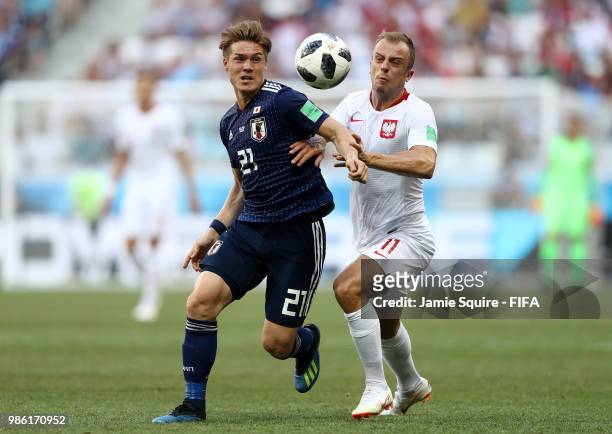 Gotoku Sakai of Japan is challenged by Kamil Grosicki of Poland during the 2018 FIFA World Cup Russia group H match between Japan and Poland at...