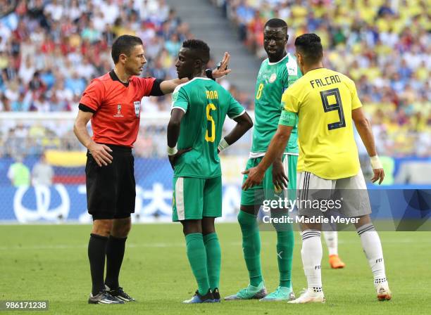 Referee Milorad Mazic speaks with Idrissa Gana Gueye of Senegal during the 2018 FIFA World Cup Russia group H match between Senegal and Colombia at...