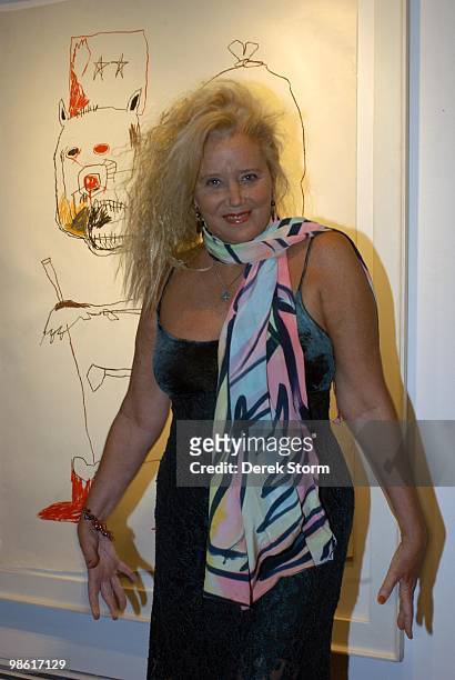 Sally Kirkland in front of a Basquiat