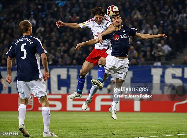 Ruud van Nistelrooy of Hamburg and Aaron Hughes of Fulham compete for the ball during the UEFA Europa League semi final first leg match between...
