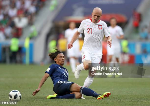 Takashi Usami of Japan tackles Rafal Kurzawa of Poland during the 2018 FIFA World Cup Russia group H match between Japan and Poland at Volgograd...