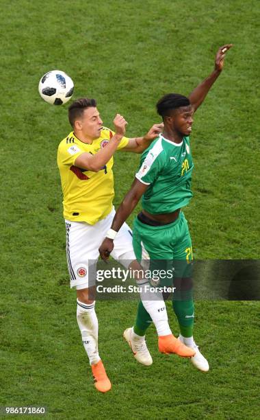 Santiago Arias of Colombia and Keita Balde of Senegal compete for a header during the 2018 FIFA World Cup Russia group H match between Senegal and...