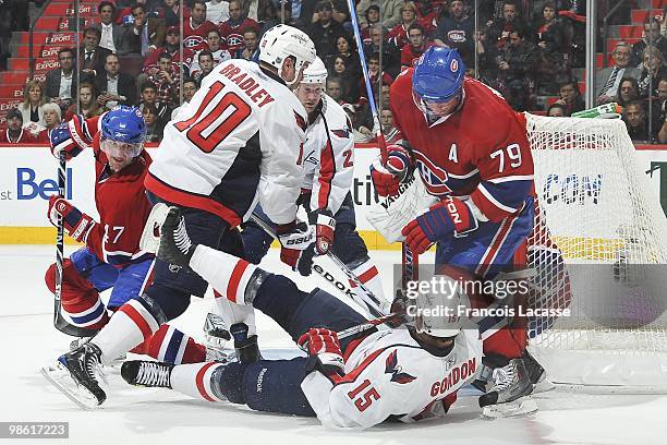 Boyd Gordon of the Washington Capitals falls in front of Andrei Markov of Montreal Canadiens in the Game Three of the Eastern Conference...