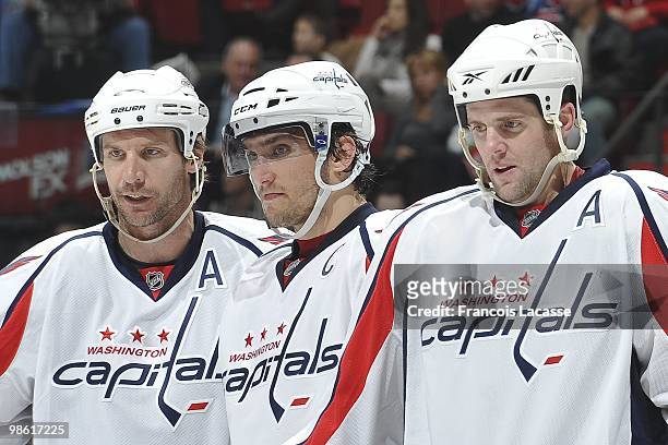 Alex Ovechkin of the Washington Capitals waits for a face off with teammate Tom Poti and Mike Knuble in the Game Three of the Eastern Conference...