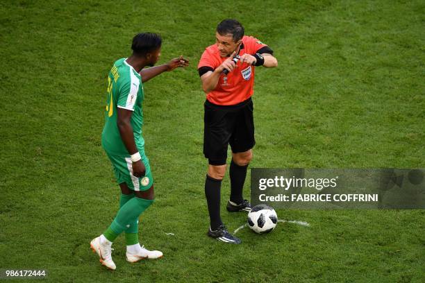 Senegal's forward Keita Balde speaks with Serbian referee Milorad Mazic during the Russia 2018 World Cup Group H football match between Senegal and...