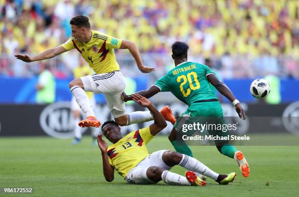 Santiago Arias of Colombia collides with Yerry Mina of Colombia as he is challenged by Keita Balde of Senegal during the 2018 FIFA World Cup Russia...