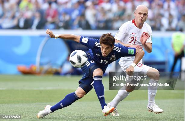 Yuya Osako of Japan competes for the ball with Rafal Kurzawa of Poland during the 2018 FIFA World Cup Russia group H match between Japan and Poland...