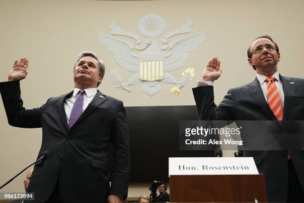 Deputy Attorney General Rod Rosenstein and FBI Director Christopher Wray are sworn in during a hearing before the House Judiciary Committee June 28,...
