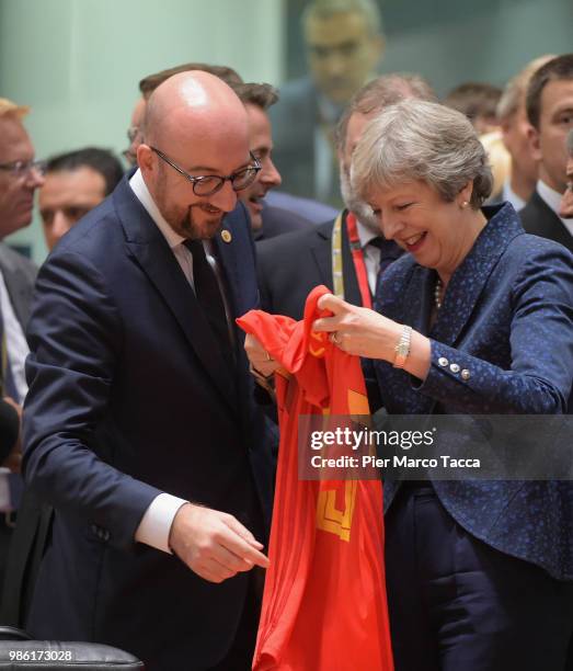 Charles Michel, Prime Minister of Belgium shows the jersey of Belgium football team to Theresa May, Prime Minister of United Kingdom during the EU...