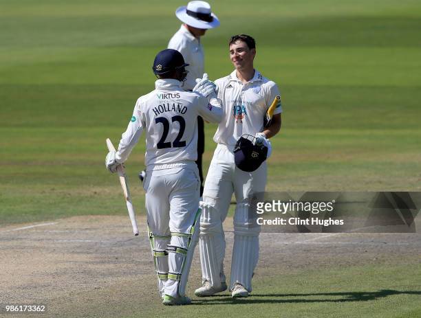 Joe Weatherley of Hampshire celebrates with team-mate Ian Holland after he reaches a century during day four of the Specsavers County Championship...