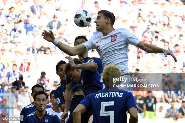 Poland's defender Jan Bednarek heads the ball during the Russia 2018 World Cup Group H football match between Japan and Poland at the Volgograd Arena...