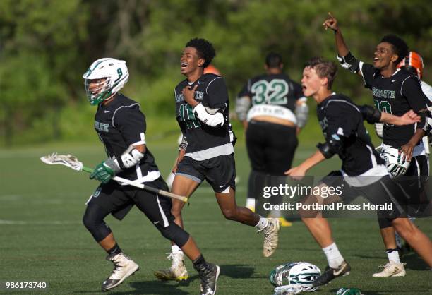 Waynflete teammates rush the field after defeat North Yarmouth Academy 18-6 in the Class C semifinal.