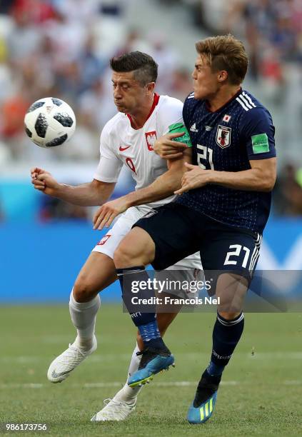 Gotoku Sakai of Japan challenge for the ball with Robert Lewandowski of Poland during the 2018 FIFA World Cup Russia group H match between Japan and...